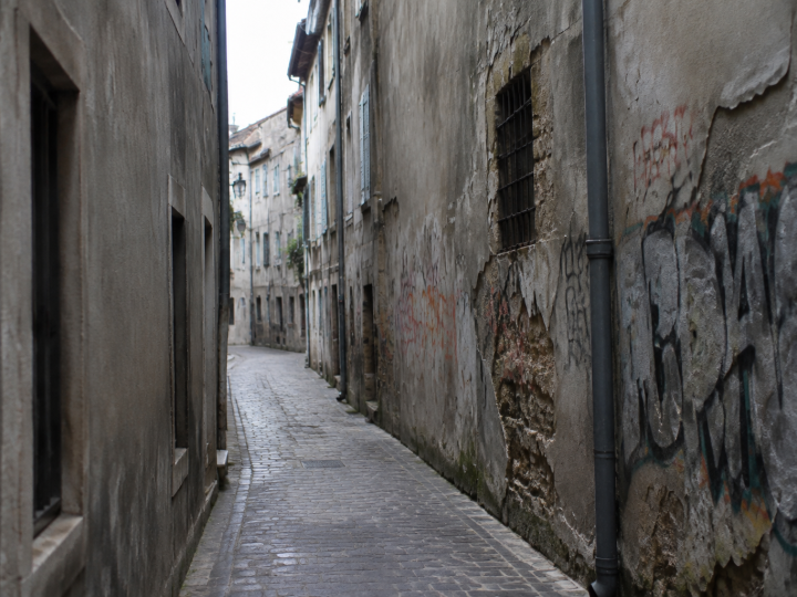 Rues etroites facades grises avec graffiti degradation visible